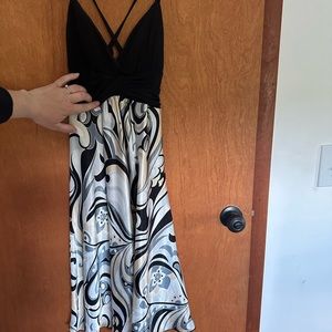 Dress with dross-cross straps in the back. Black top with pattern on bottom.